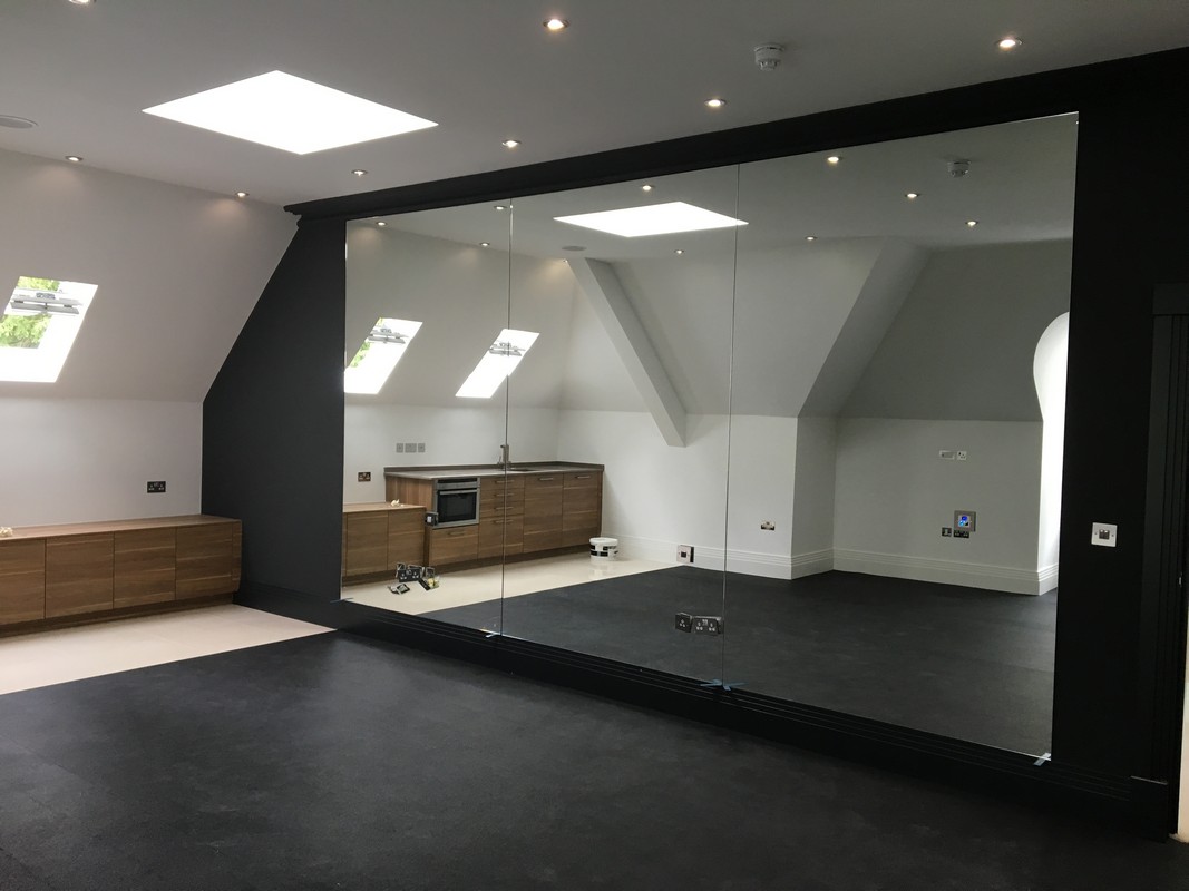 Frameless glass wall dividing loft conversion in Regent's Park